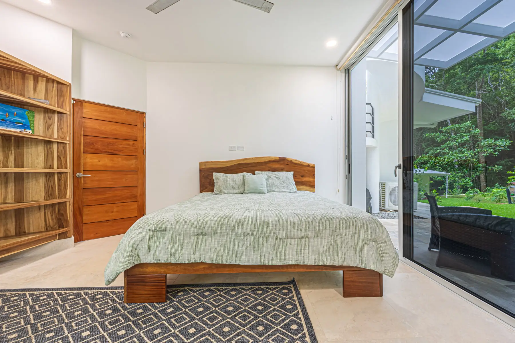 A king bedroom with sliding doors onto a private patio