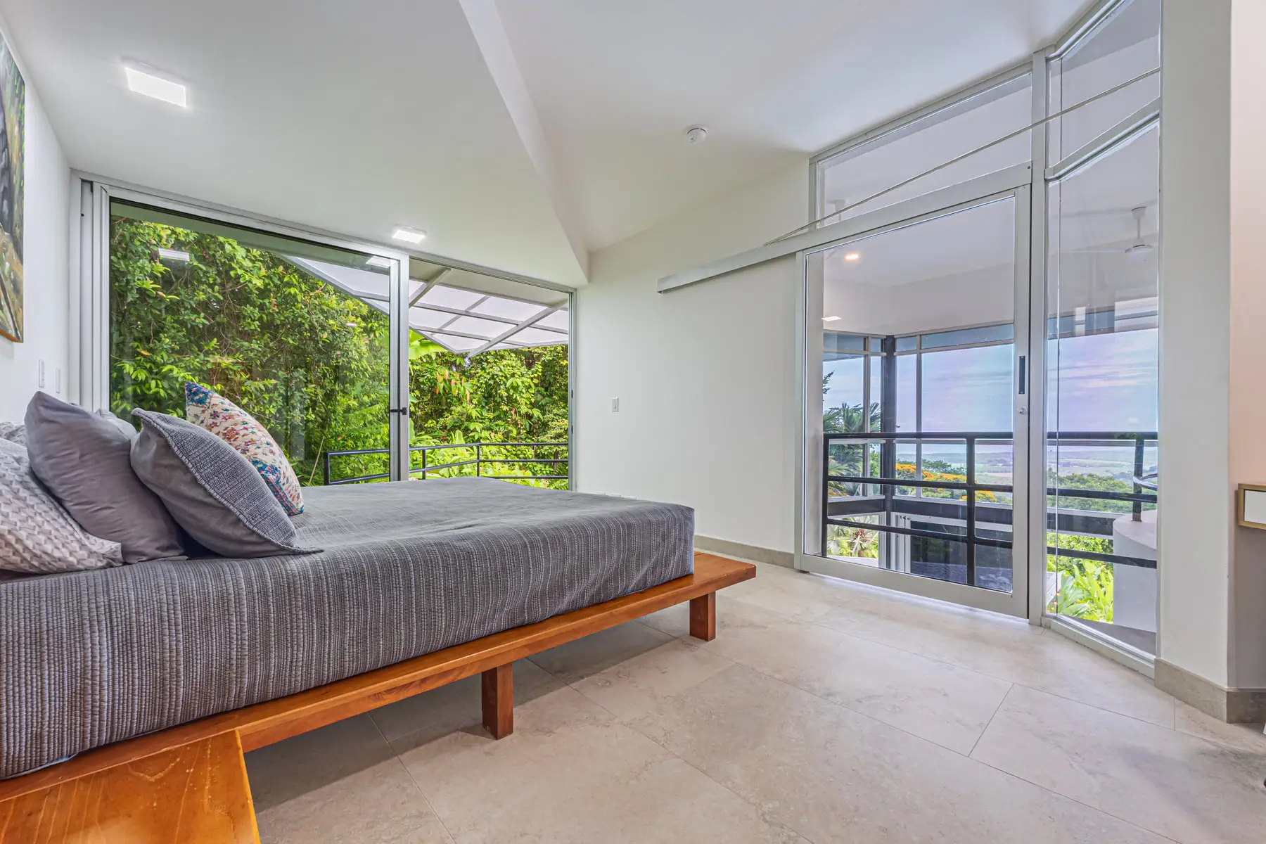 A bedroom with a writing desk and a view into the canopy