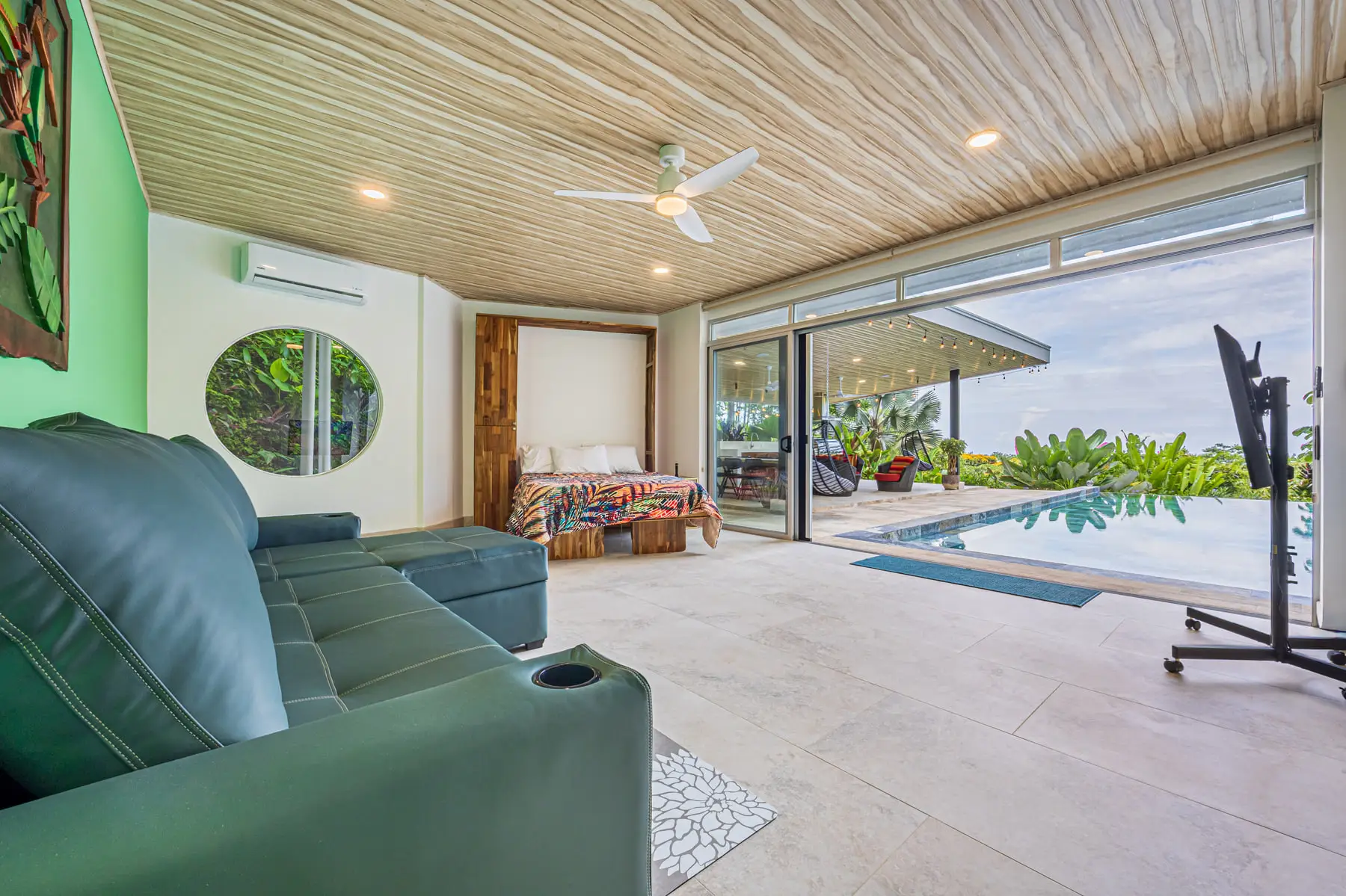 The covered lounge opening straight onto the pool terrace
