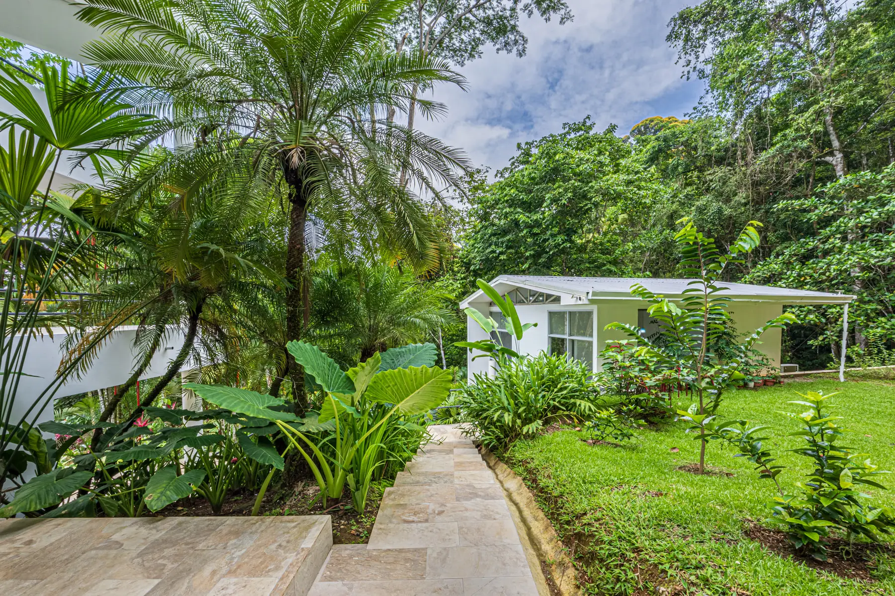A stone path through the planted gardens on the property