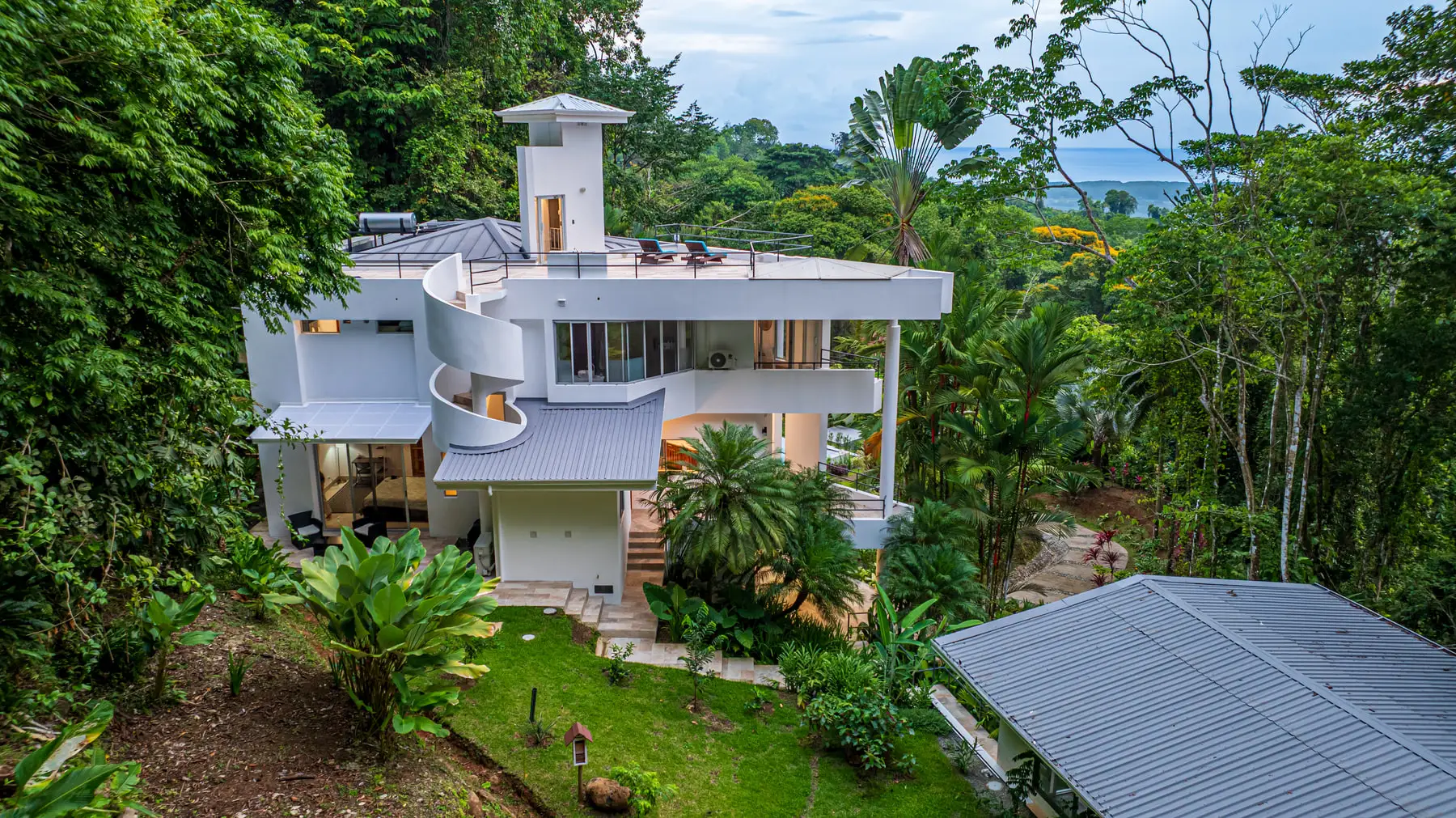 The house from the air, set into the forest canopy above the Central Pacific coast