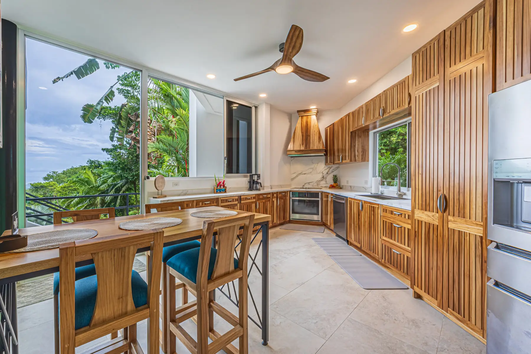 The kitchen island with bar seating, open to the dining area and the view