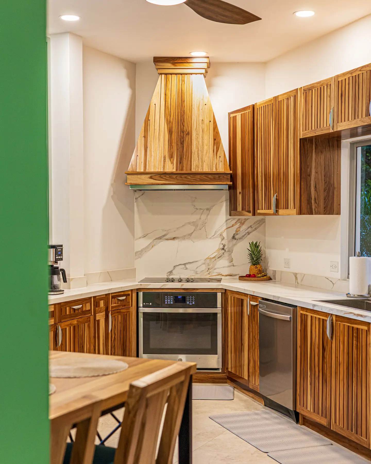 The hardwood range hood and stone splashback in the kitchen