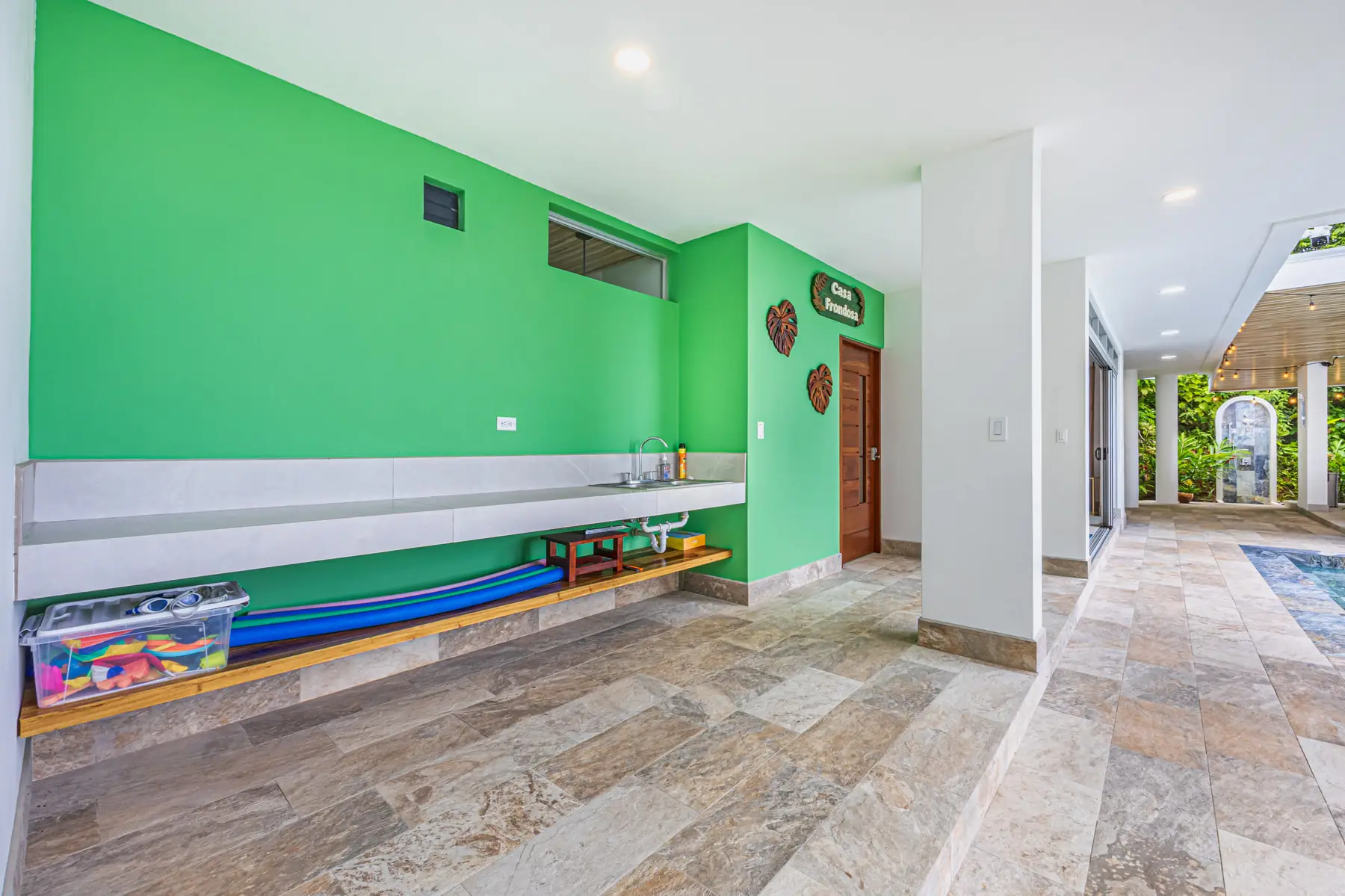 Boards racked on the wall of the covered ground floor, ready for the beach